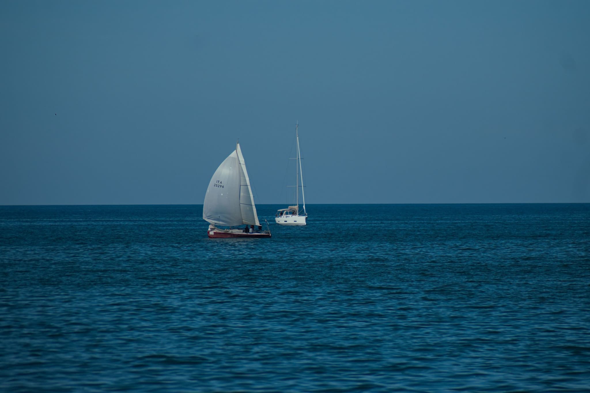 A sailboat under sail on deep blue water